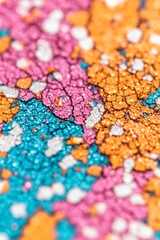 Wall Mural - Close-up of colorful glitter with a cracked texture.