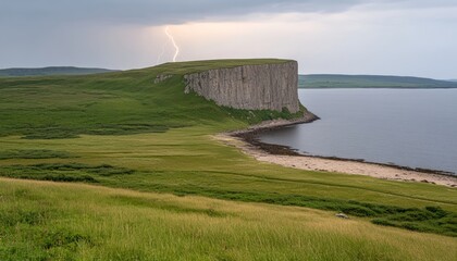 Wall Mural - Dramatic lightning strike over a tall sea cliff with a sandy beach and green grass.