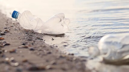 Wall Mural - bottle floating on water. glass and plastic bottle pollutes the river, the concept of recycling garb