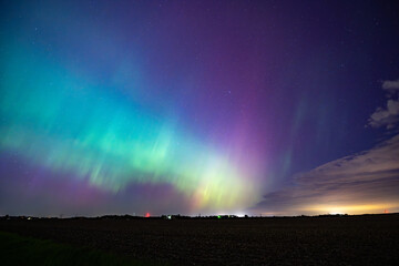 Wall Mural - Northern Lights Storm on May 11th 2024 from Iowa City, Iowa, USA with a cloud being illuminated by a light below. 5.11.24