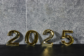 Wall Mural - golden  numbers 2025 two thousand twenty five new year near a marble gray wall 