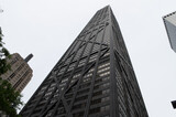 Looking up to a black skycraper in downtown chicago