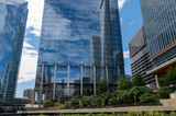 Looking at skycrapers in the mirror of an other skycraper in downtown chicago