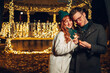 © Zamrznuti tonovi - Loving jolly couple with sparklers hugging on a street on new year's eve