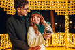 © Zamrznuti tonovi - A festive couple is celebrating new year on a city street.