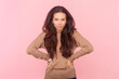 © khosrork - Portrait of angry aggressive woman with wavy hair, arguing with somebody, keeps hand on hips