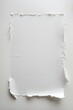 © NKTN - Torn white paper on a plain background, edges frayed, center intact, texture visible