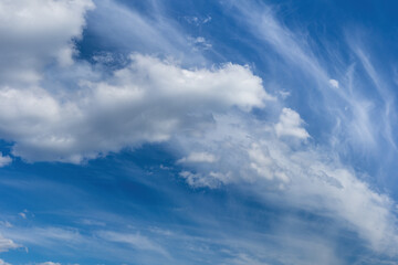 Wall Mural - blue sky with white textured clouds. serene cloudscape
