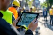 © Nognapas - Everyone needs to be on the same page. Shot of a group of architects using a digital tablet at a building site.