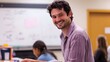 © Dandelions1706 - A Smiling Man in a Plaid Shirt Sits at a Desk in a Classroom Setting