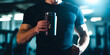 © LK  - Man holding sports shaker with protein in his hand, on background of gym. Protein nutrition concept. .
