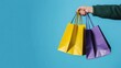 © kiki__ - Hand Holding Colorful Shopping Bags