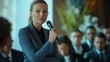 © Nathaphat - Confident Woman Speaking at Business Event