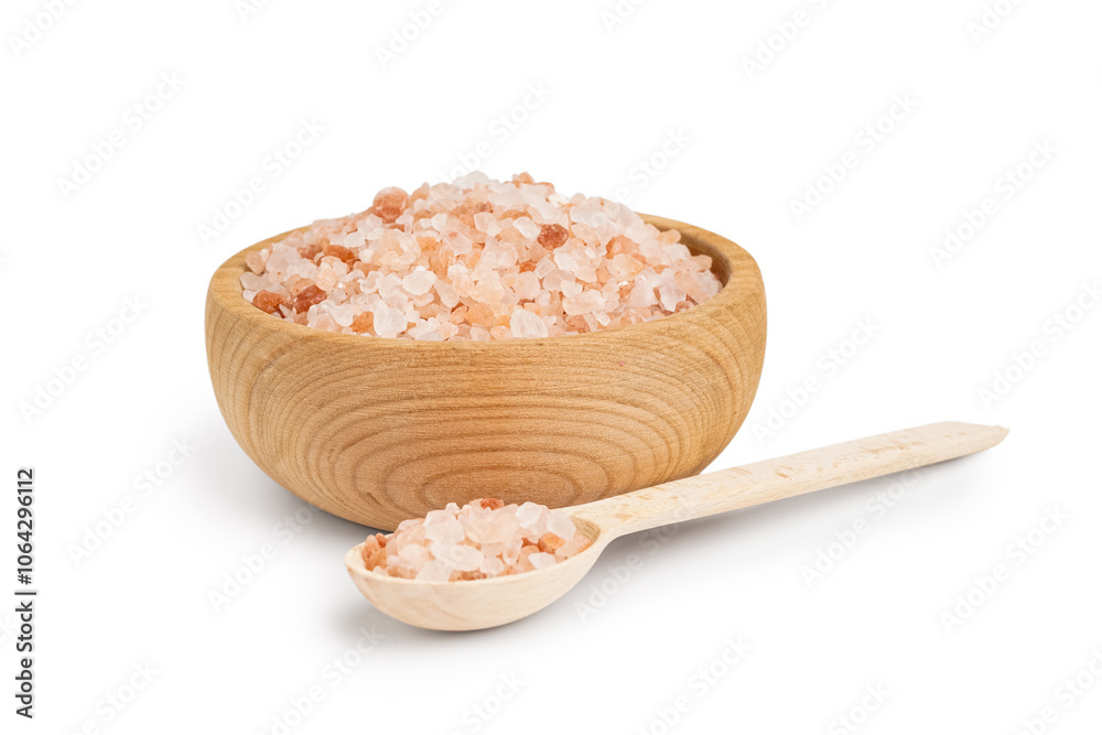 Wooden bowl and spoon with Himalayan pink salt on white background
