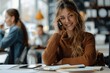 © zhuan - Cheerful Businesswoman on Mobile Phone Taking Notes at Work Desk