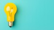© Phichaphat - Yellow Lightbulb on Blue Background