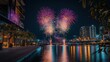 © afridwi - A vibrant fireworks display over a serene waterfront at night.