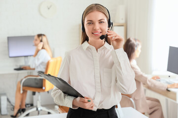 Wall Mural - Female technical support agent with clipboard in office