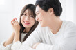 © kapinon - Close-up of a man and woman looking at the camera as a couple Focus on the woman
