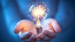 © Phichaphat - Hand Holding Lightbulb with Sparks