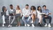 © Prostock-studio - Group of multiracial young people waiting for job interview, talking to each other and smiling
