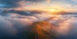 Mountain ridge shrouded in mist at sunrise.