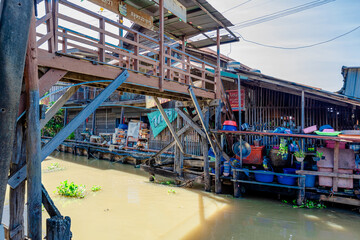 Wall Mural - Background of high angle view from wooden bridge in community market area crossing canal at tourist attraction, community lifestyle of people living together in a mutually beneficial way.