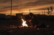 © DK_2020 - A migrant warms his hands by a fire while waiting to be processed by Border Patrol