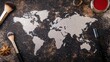 © Gencraffic - A creative arrangement of a world map made from glitter on a textured surface, surrounded by makeup brushes and decorative items.