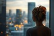 © Vooglo - Professional business woman looking through window of her office skyscraper looking