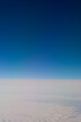 © Mint Images - View of the sky at high altitude above the clouds, mid air view through a window