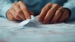 © Intelligent Horizons - Close up of frustrated hands tearing and crumpling up certificates in a dramatic scene with a crashing financial graph visible in the out of focus background