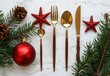 © SnapScape - Christmas table setting with golden cutlery and red decorations