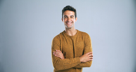 Fototapete - Studio, smile and man with portrait for arms crossed, positive attitude and ambition by backdrop. White background, male person and teacher with confidence for career, knowledge and mockup space