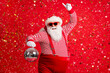 © deagreez - Photo of retired old man grey beard hold vintage disco ball dance funky wear santa x-mas costume suspenders sunglass gloves striped shirt cap isolated red color background