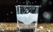 © Александр Михайлюк - A close-up of an effervescent tablet dissolving in a glass of water, with bubbles racing to the surface and a fizzing sound almost audible
