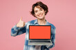 © ViDi Studio - Young IT woman she wear blue shirt white t-shirt casual clothes hold use work on laptop pc computer with blank screen workspace area show thumb up isolated on plain pink background. Lifestyle concept.