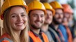 © M2A - Diverse group of young construction workers smiling together on a job site, representing teamwork, unity, and positive workplace culture in the construction industry.