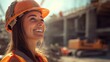 © M2A - Smiling female construction worker in hard hat and safety vest at a building site, expressing confidence and optimism in the industry. Perfect for photography of women in engineering and construction