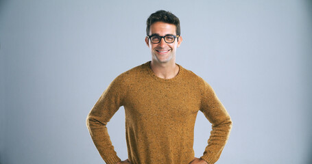 Poster - Spectacles, happy and man in portrait for studio, positive attitude and ambitious by backdrop. Gray background, male person and teacher with knowledge for career, glasses and vision by mockup space
