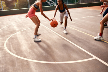 Wall Mural - Women, sports and ball on basketball court as team or athlete for challenge, cardio and training. Female people, warm up and outdoor with competition, match or player as physical activity or exercise