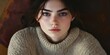 © Jayk - Young woman in a cozy sweater, looking introspective in warm indoor light, self-portrait style, authentic emotions