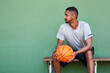 © peopleimages.com - Man, wall background and thinking as athlete for basketball for game, skill or training ideas. Male person, mockup space and coaching advice for advertising, wellness or planning in exercise or sport