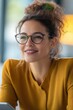 © Andrii  - Diverse Businesswoman Smiling While Using a Tablet in a Bright Workspace