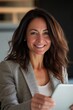 © Andrii  - Close-Up of a Happy Woman Working on a Tablet in a Chic Office Space