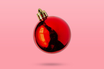 Wall Mural - Red Christmas ball isolated on pink background