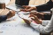 © Wasan - Businessman meeting with consultants discussing data analysis, charts and graphs in financial reports to plan investments and increase company profits.