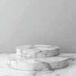 © LENNAMATS - Minimalist display of white marble pedestals on a luxurious marble background in an elegant setting