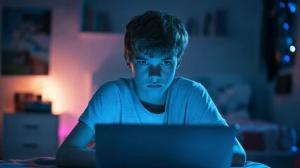 Poster - Teen boy focused on laptop screen in a dimly lit bedroom during the night, engaging in online activities or gaming