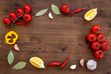 Wall Mural - Cooking concept with tomatoes and chili peppers, vegetables spices on the kitchen desk top